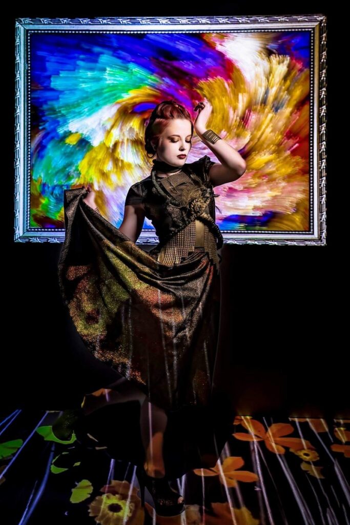 Deven Skye posing before a painted frame