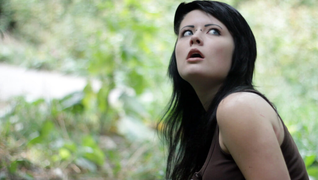 Deven Skye looking skyward in a film still